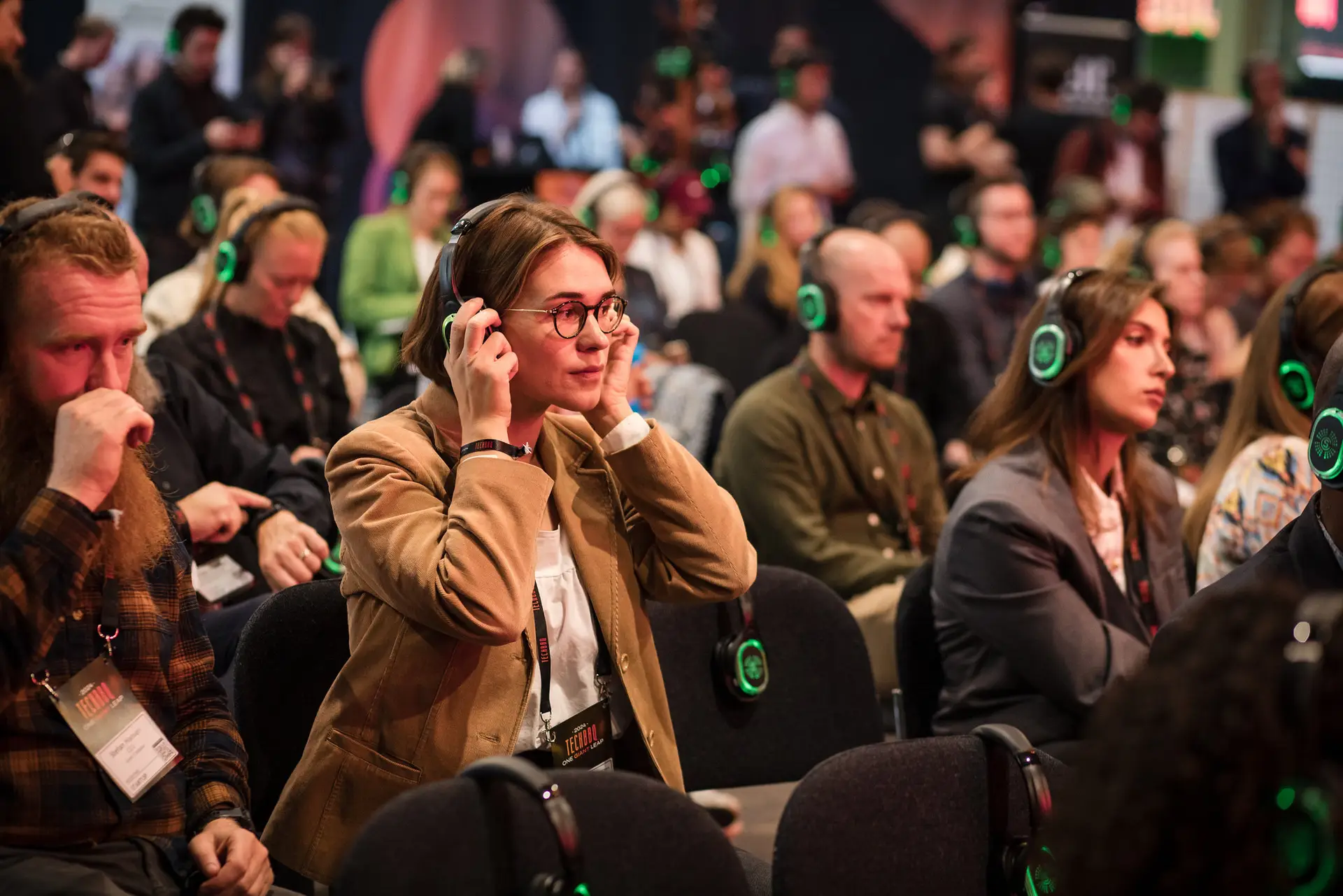 TechBBQ audience wearing headphones during a session
