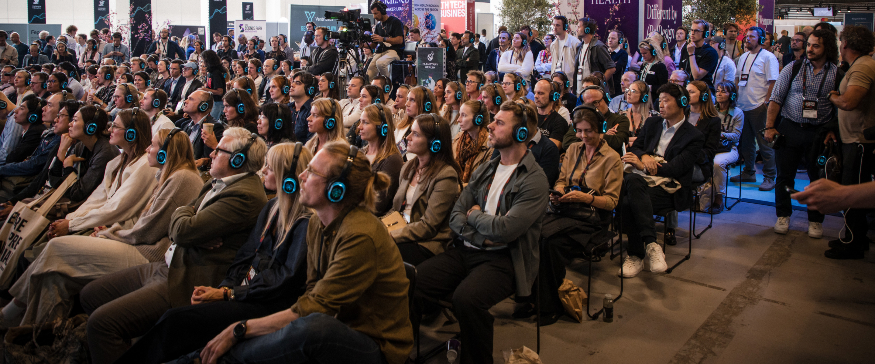 TechBBQ attendees wearing headphones during a session