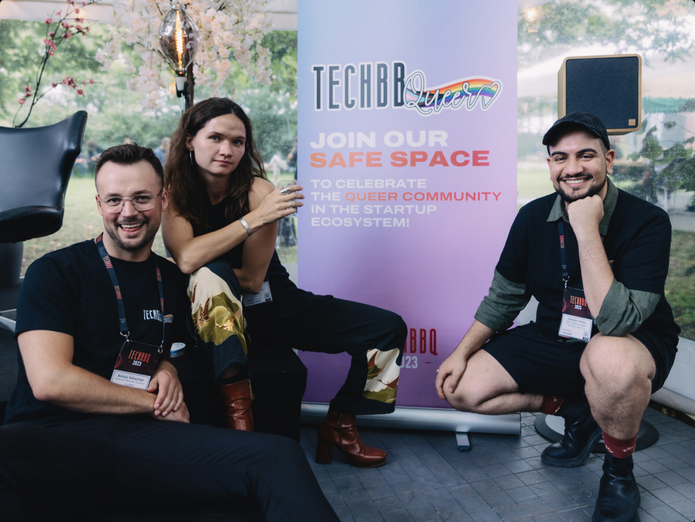 TechBBQueer attendees at TechBBQ with a rainbow banner celebrating the queer community in the startup ecosystem