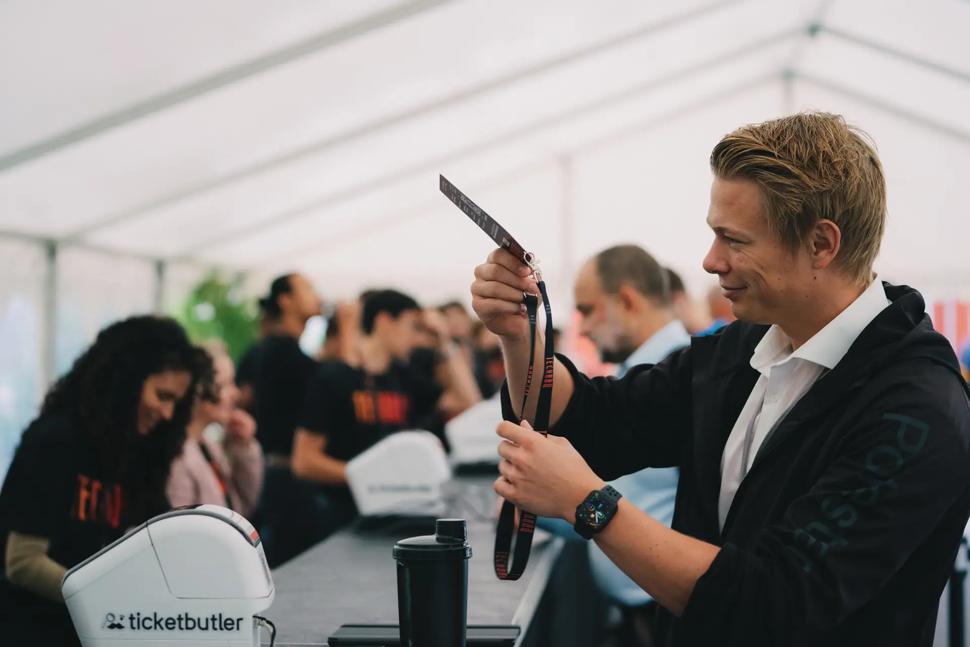 Startup founders and attendees networking at a TechBBQ booth